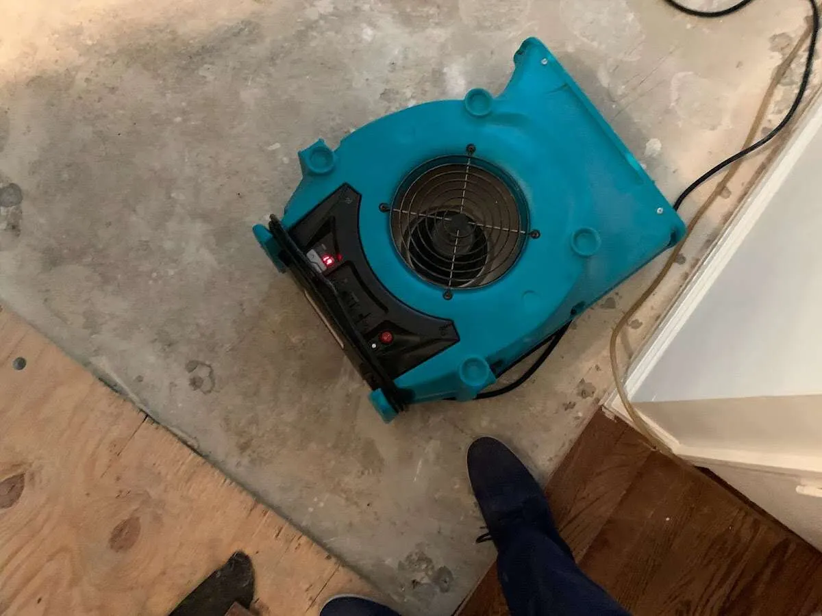 Air mover drying subfloor during Leak Detection & Repair in Oconomowoc